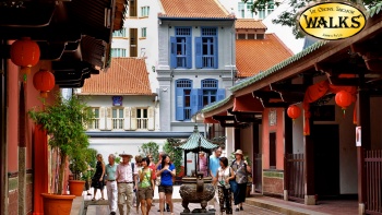 Group of visitors walking along Chinatown district, the oldest Hokkien-Chinese temple in Singapore
