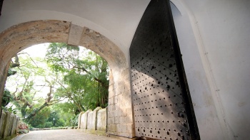 View of the arch of the Gate and full view of the metal gate at Fort Canning Park