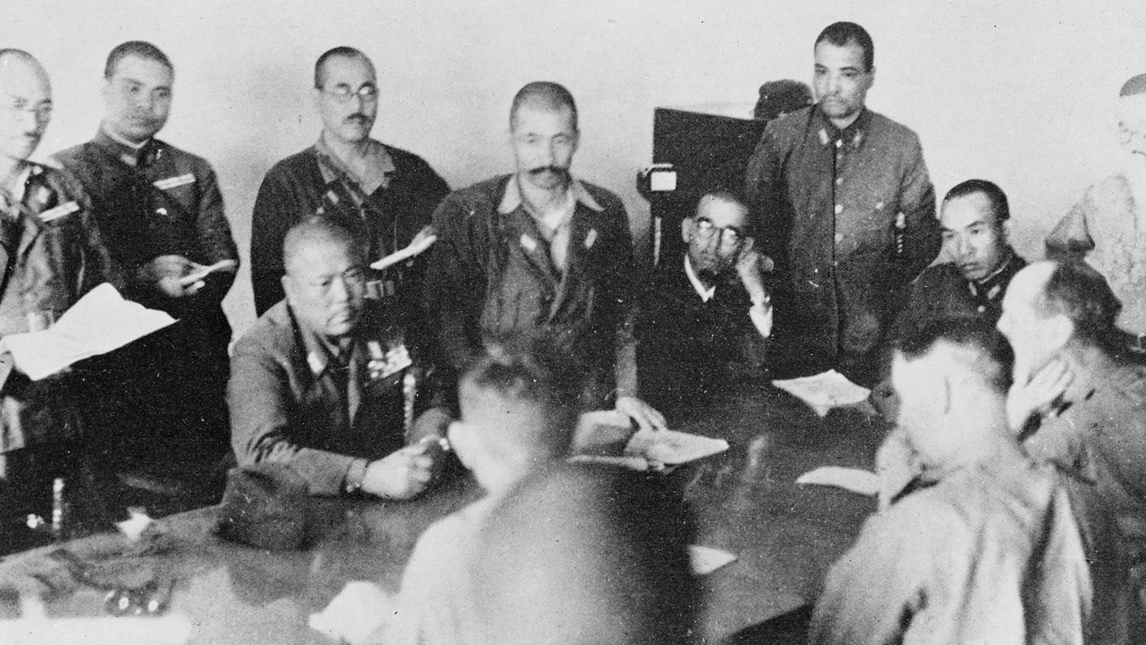 British soldiers signing the document to surrender Singapore over to the Japanese on 15 February 1942