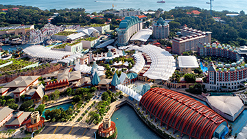 Aerial view of a modern resort with lush greenery, where Singapore event planners embrace sustainable practices to cut paper and plastic waste.