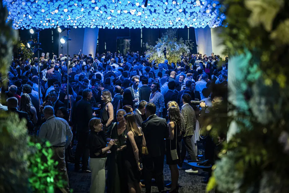 Young presenter showcasing a mental health app at a medical conference, with an engaged audience and screen features.