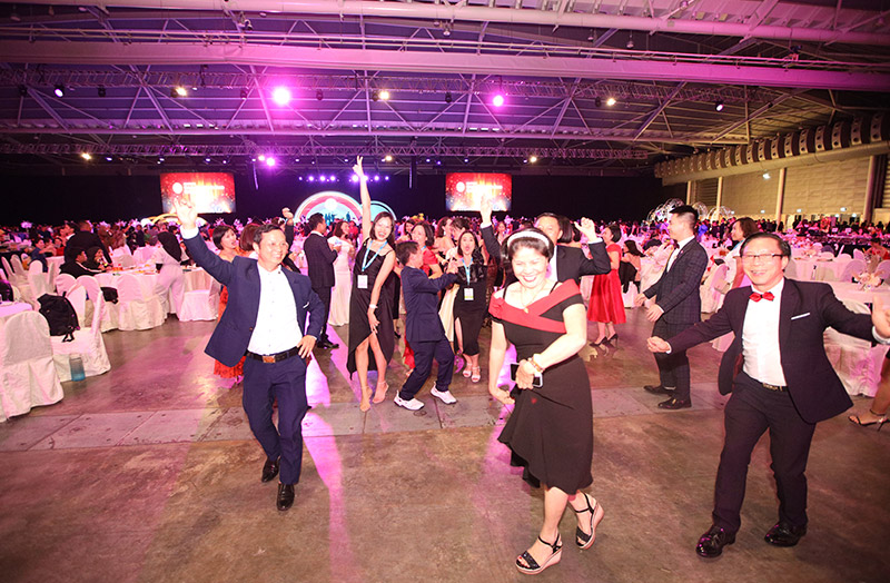 Attendees dance during an evening leisure event during the retreat at one of Singapore's large MICE venues - Singapore Expo.
