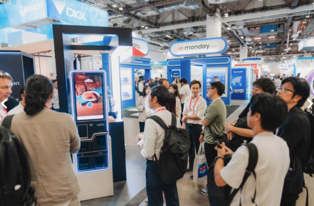 People gather at an exhibition booth with interactive display at Retail’s Big Show in Singapore, held in Sands Expo and Convention Centre