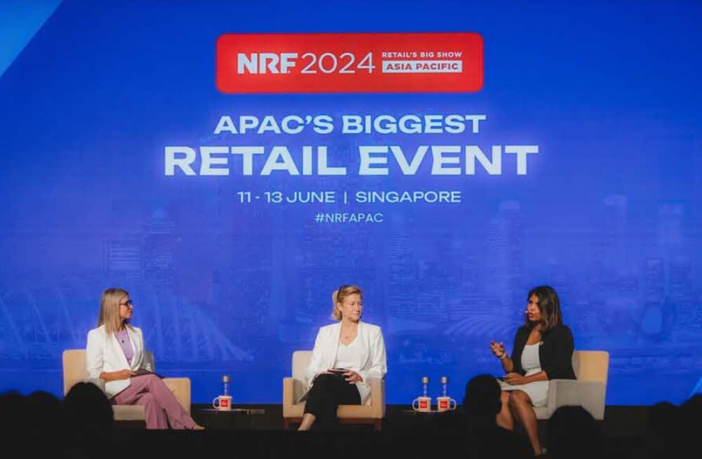 Three panelists speak on stage at NRF 2024 Asia Pacific's 'Fast Track Your Success'