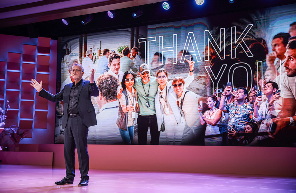 Porsche executive addresses the crowd with a 'Thank You' message displayed, ending the Porsche Global Dealer Launch event in Singapore