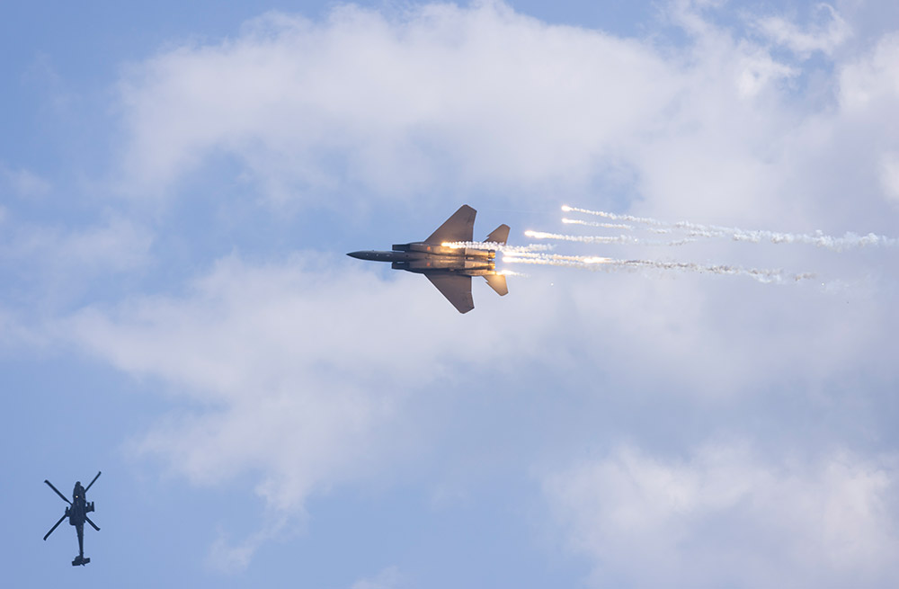 Sky stunt with fireworks by fighter plan during Singapore Airshow 2024.