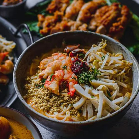Couple having the Original Katong Laksa