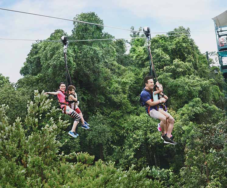Family experiencing cable ride adventure in nature