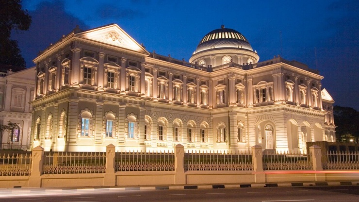 Fassade des National Museum of Singapore bei Nacht.