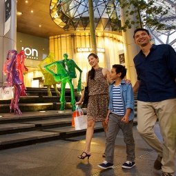 Family walking past ION facade