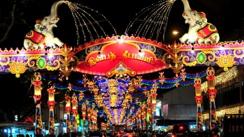 Deepavali light up along the road with cars and pedestrian crossing