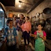 Young family exploring a mock kitchen circa 1950s, recreated at the Chinatown Heritage Centre