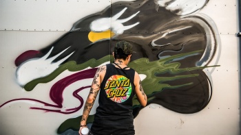 An artist working on his graffiti. 