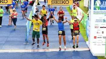 4 winners at the finishing line of the Standard Chartered Singapore Marathon.