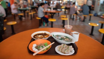 Food and drinks on a table at a hawker centre
