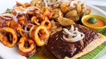 An up-close shot of sambal stringray, squid rings and clams