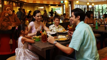 Family of four dining in Ah Meng Restaurant at the Singapore Zoo
