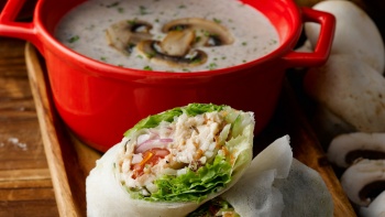 Close-up of hearty spring rolls and mushroom soup