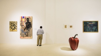 A man admiring artworks at Gajah Gallery