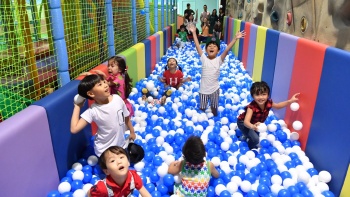 A group of children playing in the Cliff Ball Pool at Tayo Station