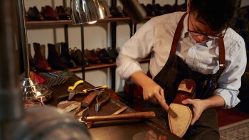 Man crafting a shoe at Ed Et Al Shoemakers