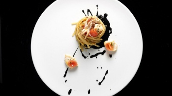 Linguine Rustichella d'Abruzzo with fresh tomato, baby squid, squid ink sauce and oregano served at Buona Terra