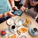 A group of people having a traditional Singaporean breakfast of kaya toast, kopi and soft-boiled eggs