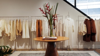 Interior of Beyond the Vines fashion store, with racks of clothes.