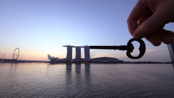 Silhouette of a key placed against Marina Bay Sands.  