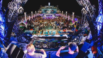 Wide shot of DJ and crowd at It’s The Ship