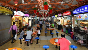 People dining with stalls on both sides.