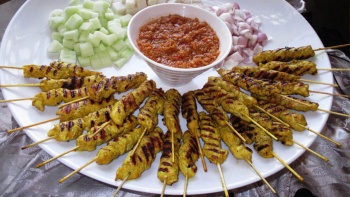 A plate of <i>satay</i> (grilled skewered meats)