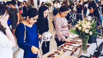 Shoppers browsing accessories at Boutiques open-concept market