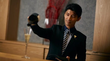 A sommelier pouring a glass of champagne at La Terre