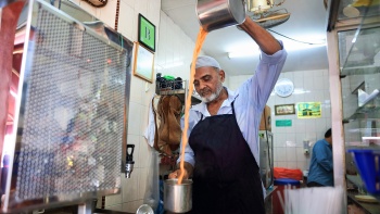 Penjual Teh Tarik menarik tehnya.