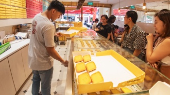Pelanggan membeli egg tart di gerai Tong Heng di Chinatown