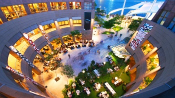 Aerial view of the dining area outside Esplanade – Theatres on the Bay in the evening featuring numerous eateries and alfresco dining