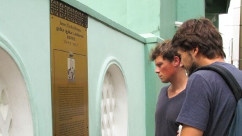Tourists reading a plague outside Masjid Jamae Singapore