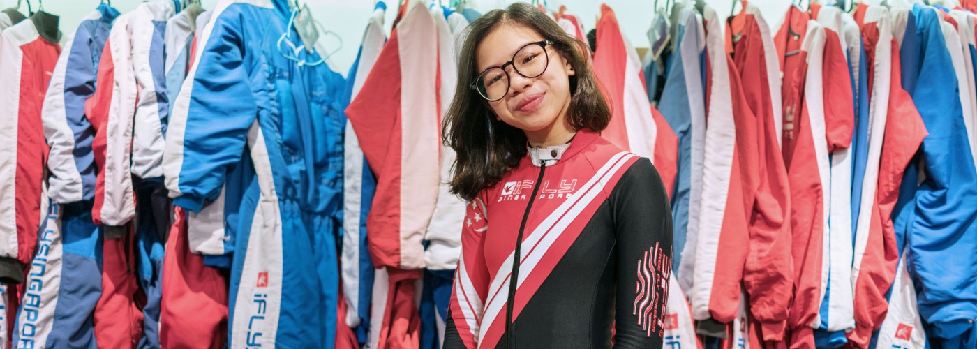 Kyra Poh strikes a pose in her skydiving suit