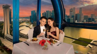 Couple enjoying a romantic dinner within the Singapore Flyer capsule
