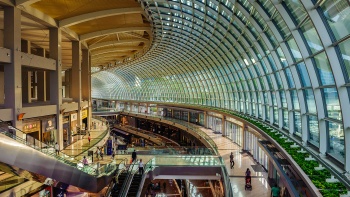 Interior shot featuring the curved corridor in The Shoppes at Marina Bay Sands
