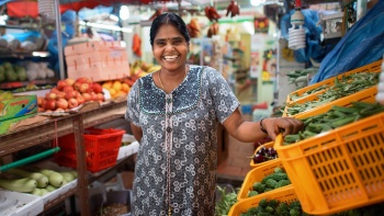 A portrait shot of a vegetable stall owner in Little India
