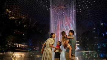 Family with two young kids admiring Jewel Changi HSBC Rain Vortex