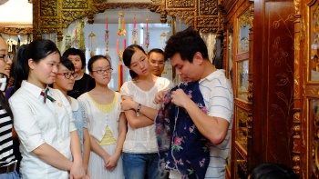 Tour guide showing artefacts in a heritage house, The Intan.
