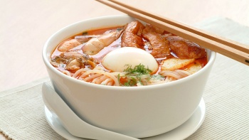 A bowl of laksa (spicy coconut milk-based noodle soup)