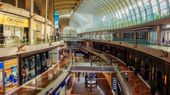 An interior view of The Shoppes at Marina Bay Sands® showing the curved corridor.