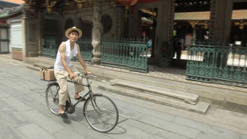 Man riding a bicycle at Trails of Tan Ah Huat Bicycle tour
