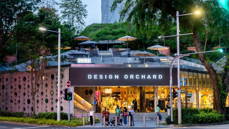 A view of the external facade of the Design Orchard store at night.