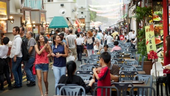 ผู้คนนั่งรับประทานอาหารริมถนนย่าน Chinatown