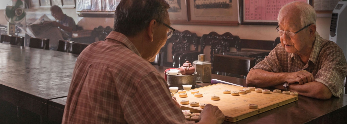 Elderly men duking it out over Chinese chess